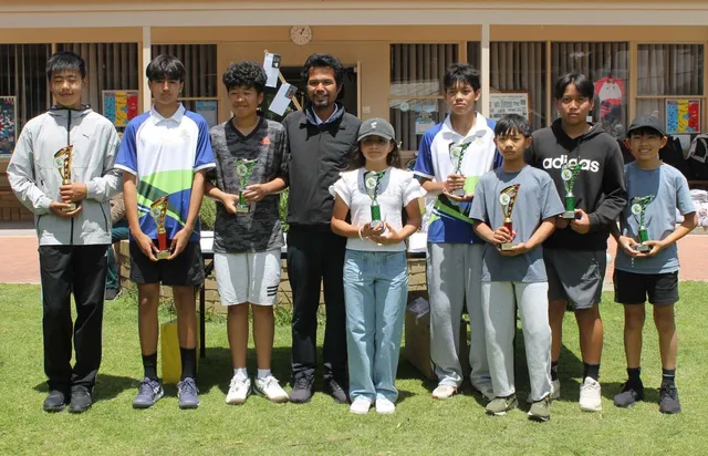 A junior team proudly wearing their medals with their coach