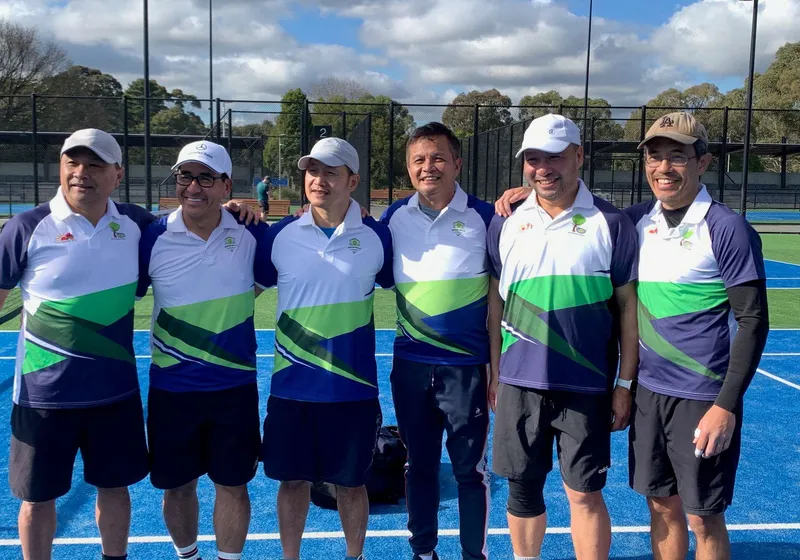 Six Burden Park men in club match kit, courtside.