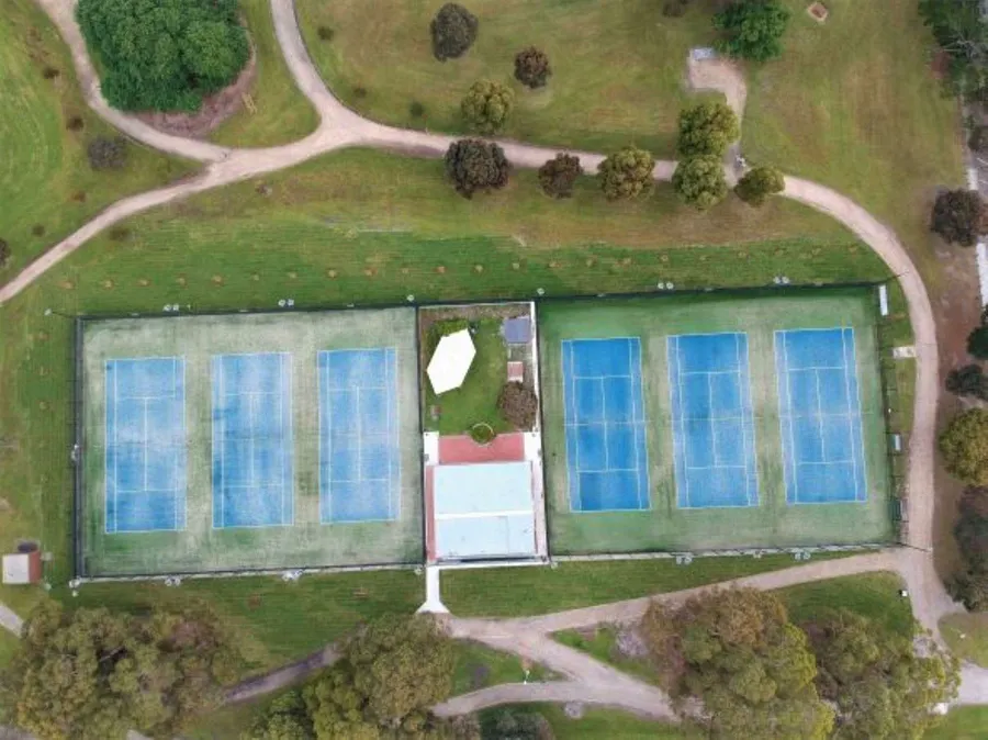 Drone view of all six Burden Park courts and the clubhouse, set among the park's gum trees