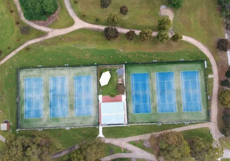 Aerial view of all six mod-grass courts and the clubhouse at Burden Park.