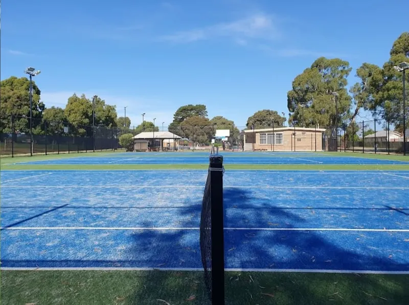 Ground-level view across the courts to the clubhouse