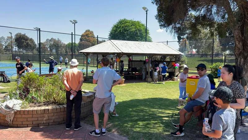 Empty courts with the clubhouse and shelter in the background on a sunny day