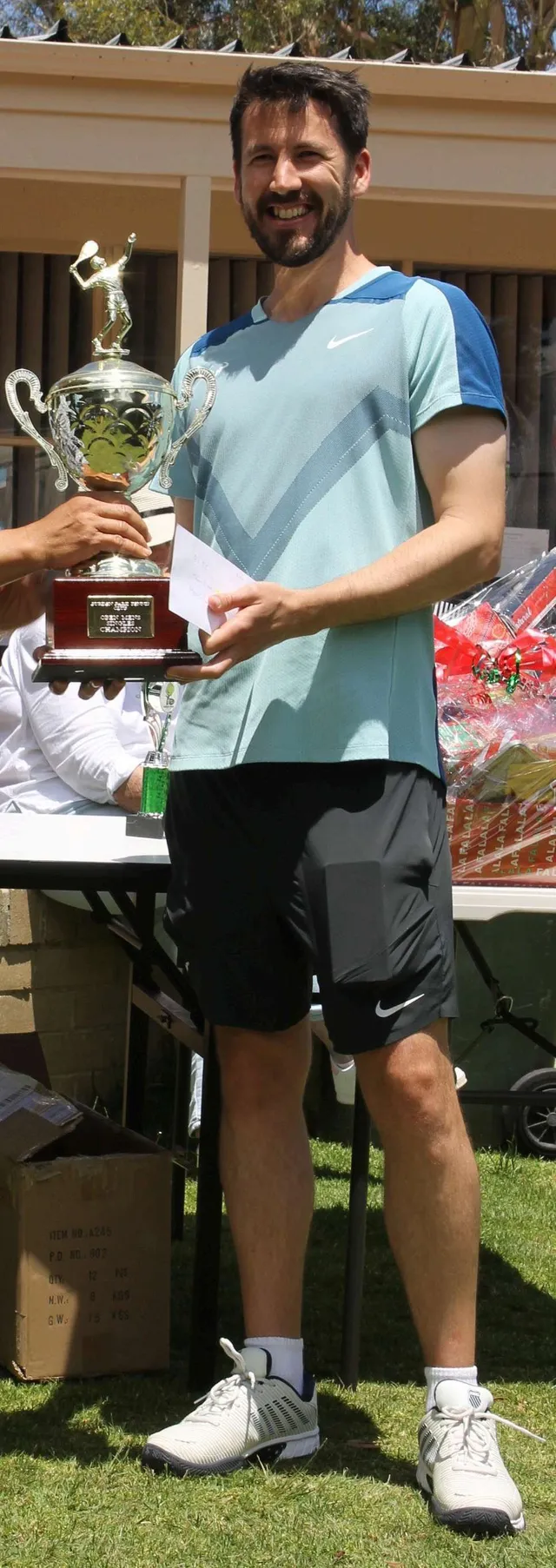 Men's Senior Singles champion Mark Young holding his trophy