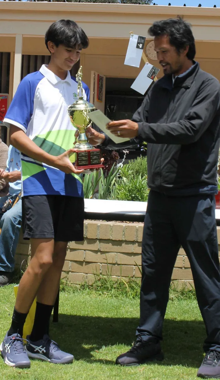 Andrew Louis, Boys' Singles champion, holding his trophy